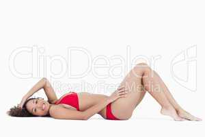 Smiling brunette woman lying down