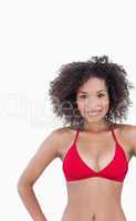 Smiling woman looking at the camera while standing in swimsuit