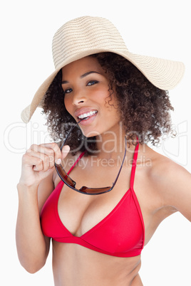 Attractive brunette woman holding her sunglasses