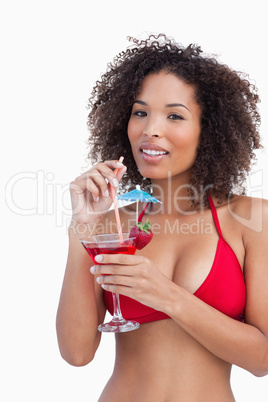 Attractive brunette holding a fruit cocktail