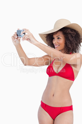 Young woman in beachwear photographing herself
