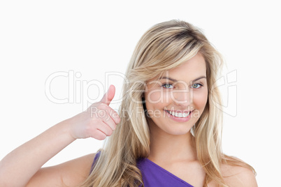 Smiling blonde woman placing her thumbs up Smiling blonde woman placing her thumbs up