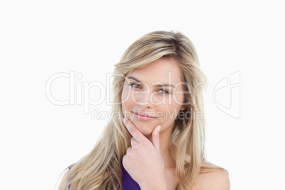 Thoughtful young woman placing her fingers on her chin