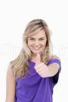 Smiling blonde woman placing her thumbs up in agreement