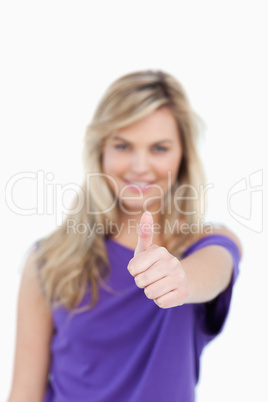 Thumbs up being placed by a blonde woman