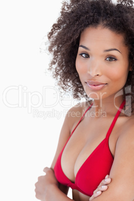 Thoughtful young woman standing with arms crossed