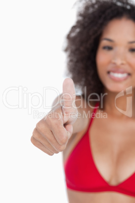 Thumbs up being placed by an attractive brunette woman