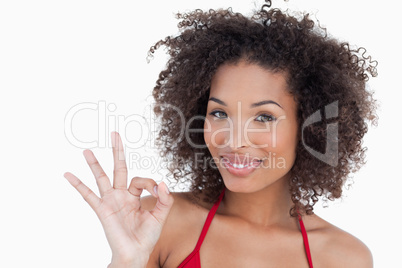 Smiling young woman showing the ok sign