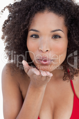Attractive brunette woman sending an air kiss