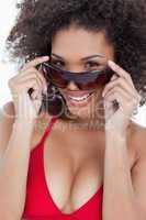 Attractive brunette holding her sunglasses while smiling