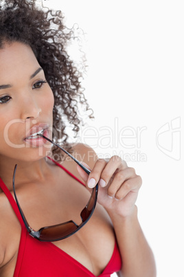 Attractive woman looking away while placing her sunglasses on he