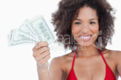 Bank notes being held by an attractive woman