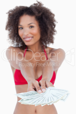 Fan of notes being held by a young woman