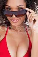 Attractive brunette woman looking over her sunglasses