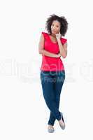Young thoughtful woman standing upright
