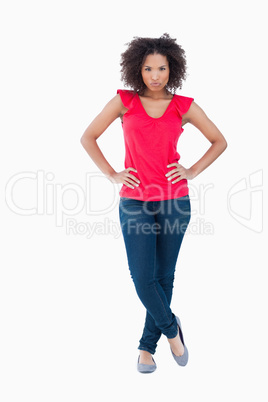 Serious young woman placing her hands on her hips