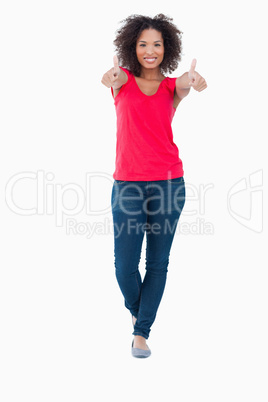 Smiling woman placing her thumbs up in satisfaction