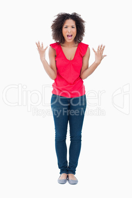 Upset brunette woman raising her arms