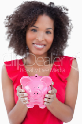 Piggy bank being held by a brunette woman