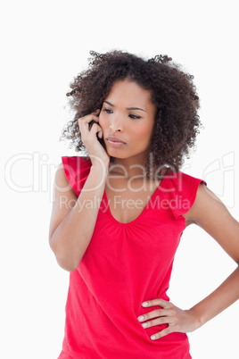 Serious brunette woman using her mobile phone