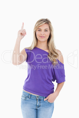 Peaceful young woman raising her finger