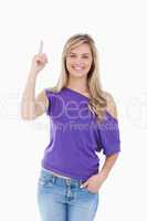 Smiling blonde woman raising her finger