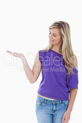Smiling woman looking at her palm up