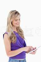 Smiling blonde woman using a tablet computer