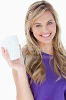 Smiling blonde woman holding a cup of coffee