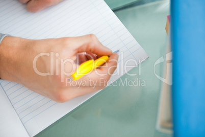 Close-up of a student hand doing his homework
