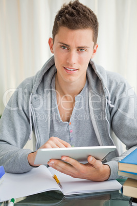 Handsome student using a touch pad