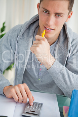 Handsome student using a calculator