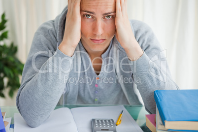 Portrait of a student holding his head