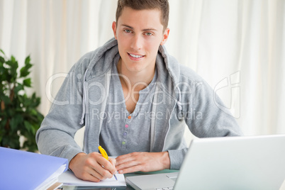 Portrait of a student doing his homework