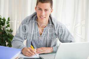 Portrait of a student doing his homework