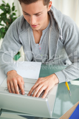Close-up of a student typing on a netbook