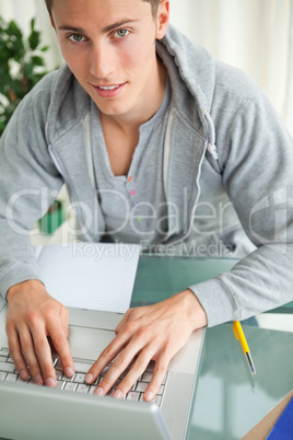 Portrait of a student typing on a netbook
