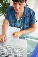 Female student doing his homework while helping with a netbook