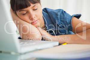 Tired female student enjoying music