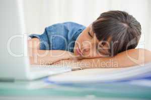 Female student sleeping on her desk