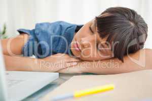 Female student sleeping on her desk