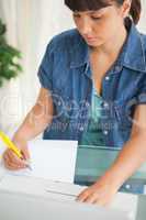 Unsmiling student doing her homework