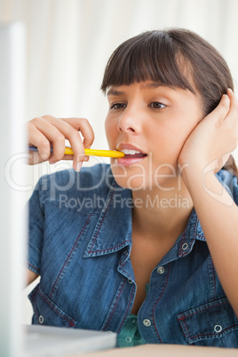 Student grimacing while chewing a pencil