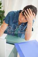 Student with a headache while doing her homework