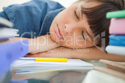 Female student sleeping among her books