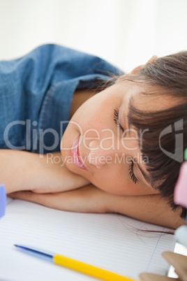 Close-up of a female student sleeping among her books