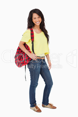 Smiling Latin student posing with a backpack