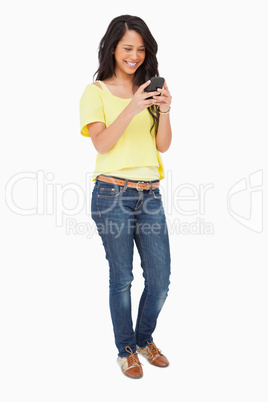 Beautiful Latin laughing while using a smartphone