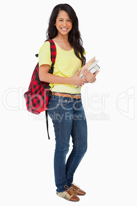 Latin student with backpack holding textbooks