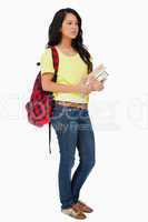 Latin student with backpack holding textbooks